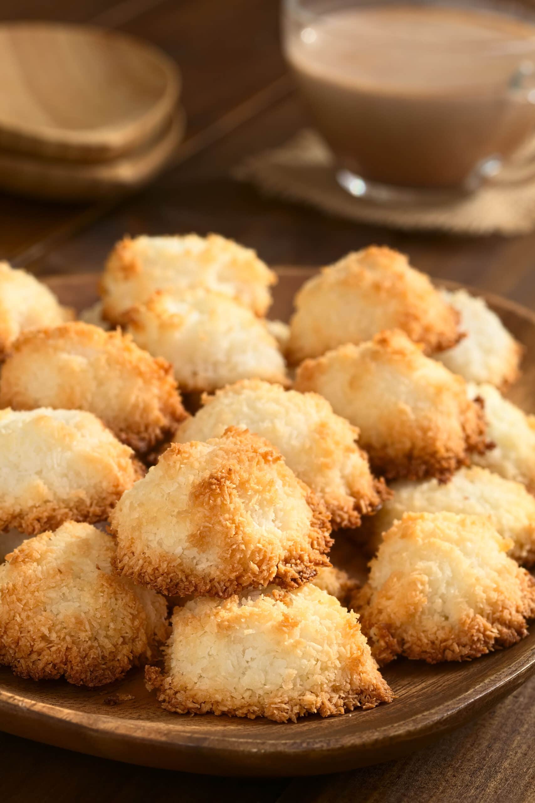 Bunch of coconut macaroons on a wooden plate.