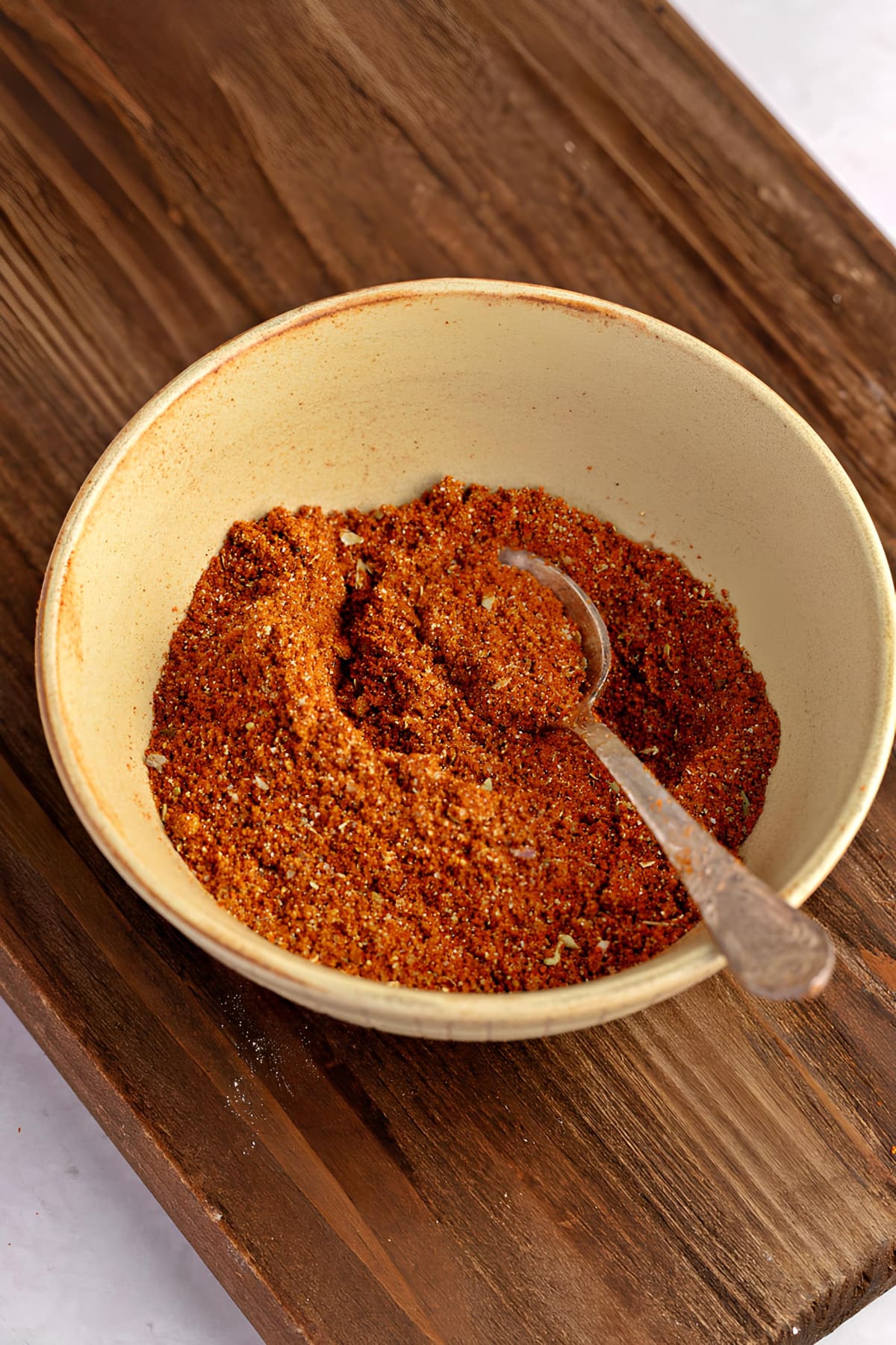 A Bowl of Burrito Seasoning on a Wooden Board