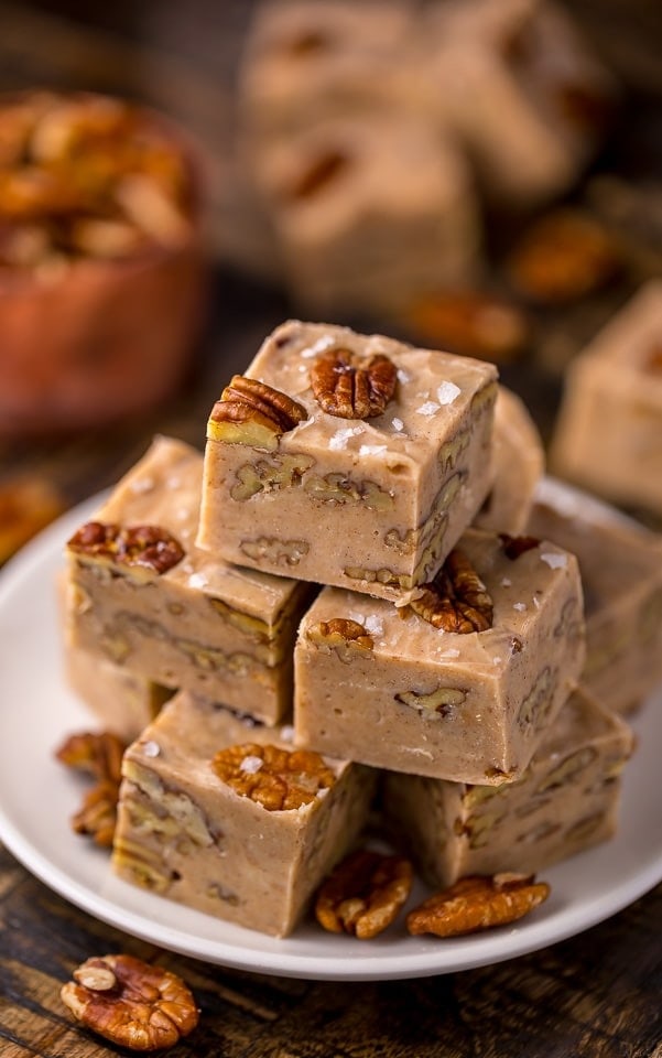 Stack of fudge with pecan on a plate. 