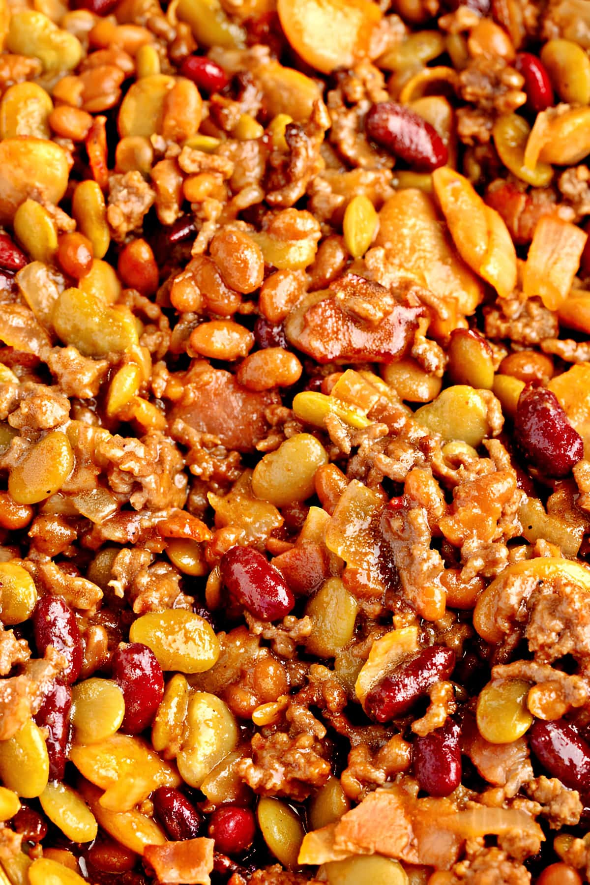 Close-up view of calico beans with ground beef, bacon and mustard powder