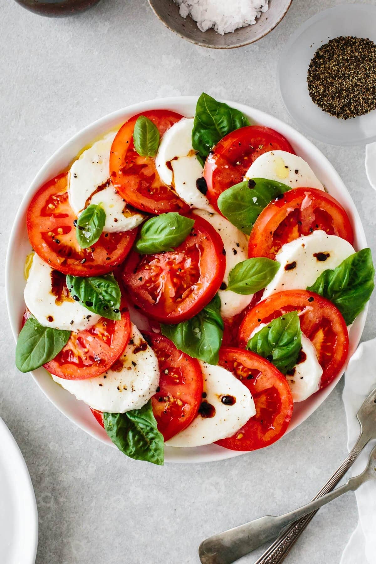 Homemade Caprese Salad with tomatoes, mozzarella, basil. olive oil and balsamic vinegar