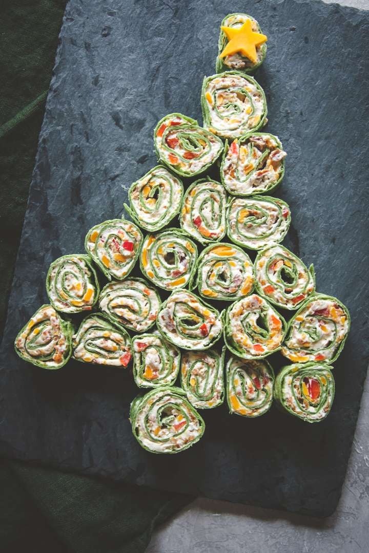 Cheddar bacon ranch pinwheel wraps shaped as Christmas tree on a concrete surface. 