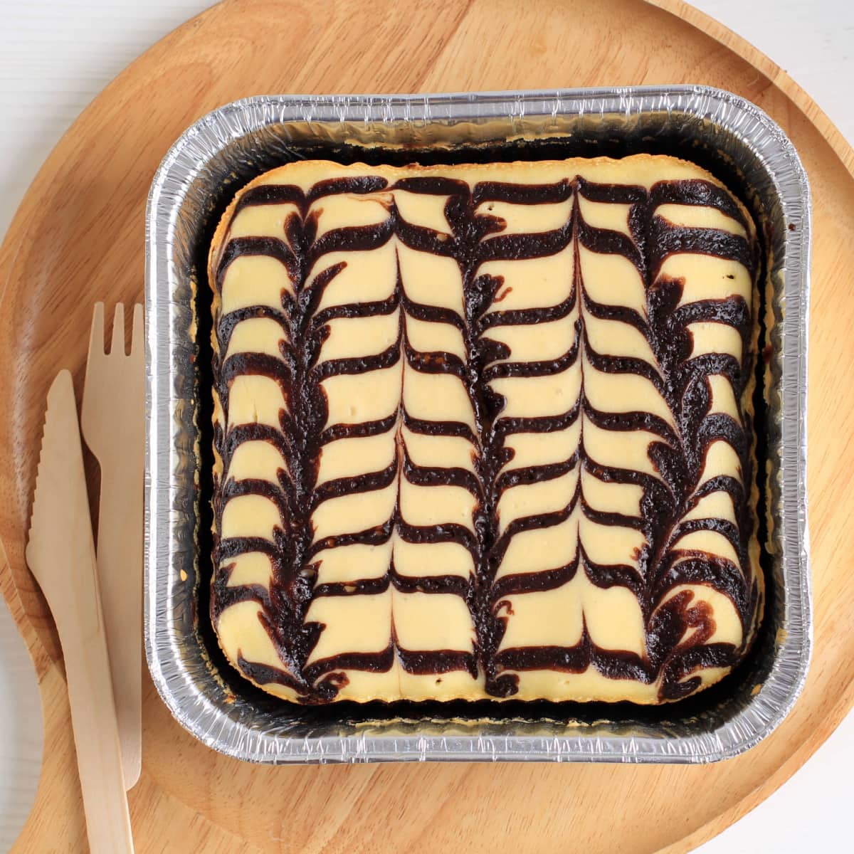 Cheesecake brownies in a baking pan. 