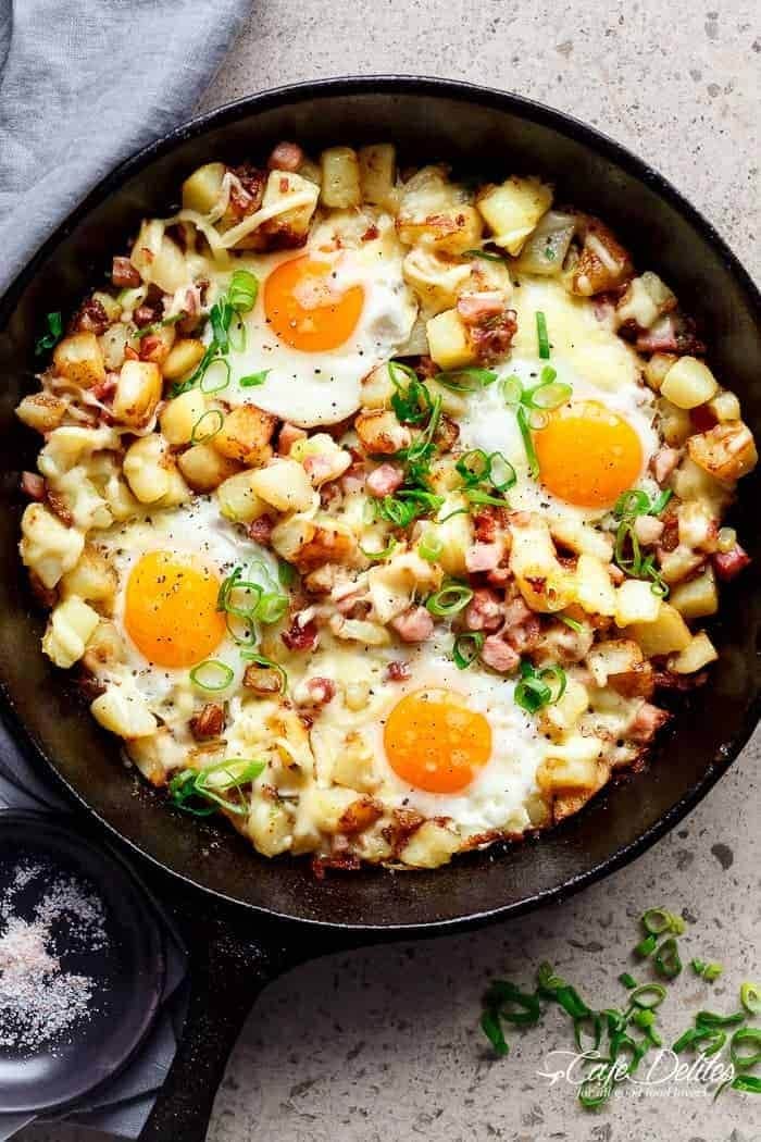 Potatoes with  eggs, potatoes, bacon, and cheese in a skillet.