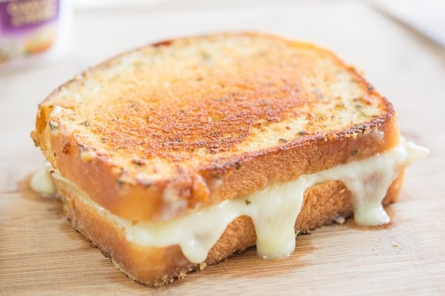 Grilled sandwich with melted cheese filling.