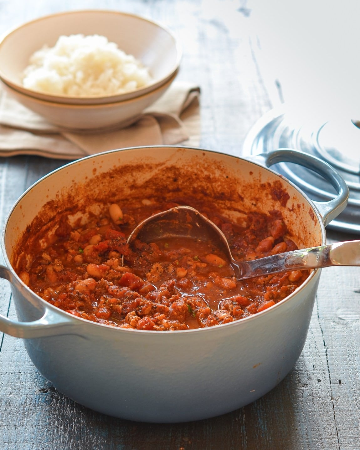 Chicken chili with beans on a pot with ladle. 