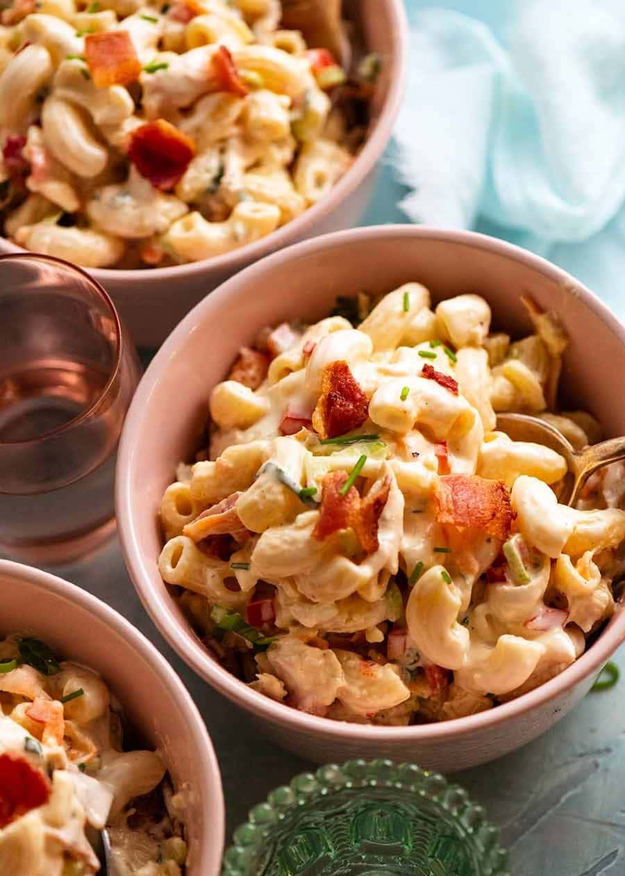 Bowls of pasta with sauce and shredded chicken. 