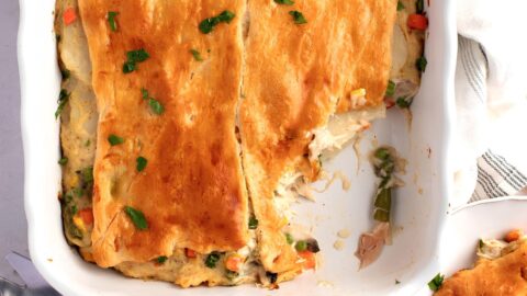 Top view of comforting chicken pot pie with crescent rolls and vegetables in a casserole