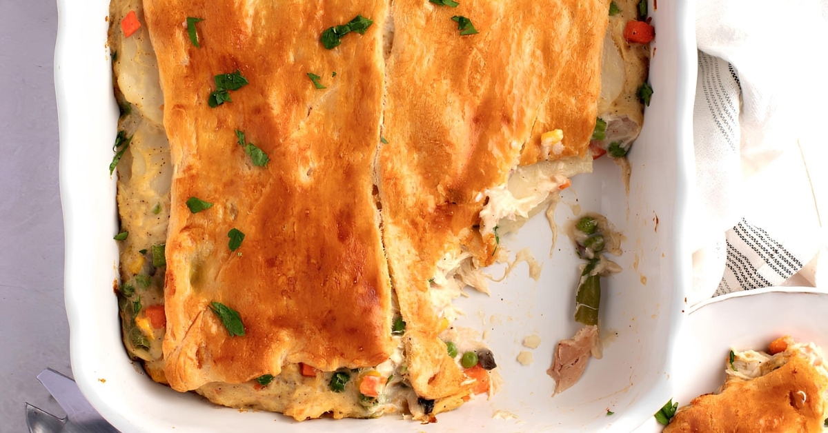 Top view of comforting chicken pot pie with crescent rolls and vegetables in a casserole