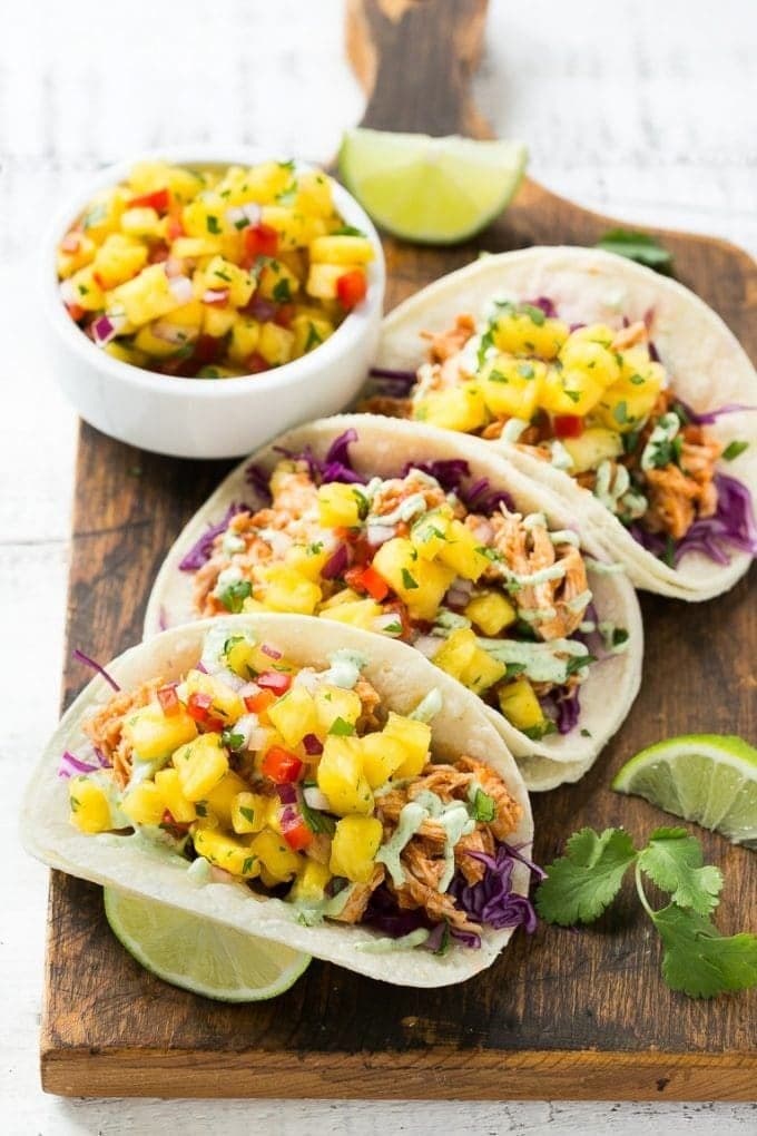 Tacos with shredded chicken, Diced pineapple, red bell peppers, red onions, lime juice, salt, and cilantro filling.