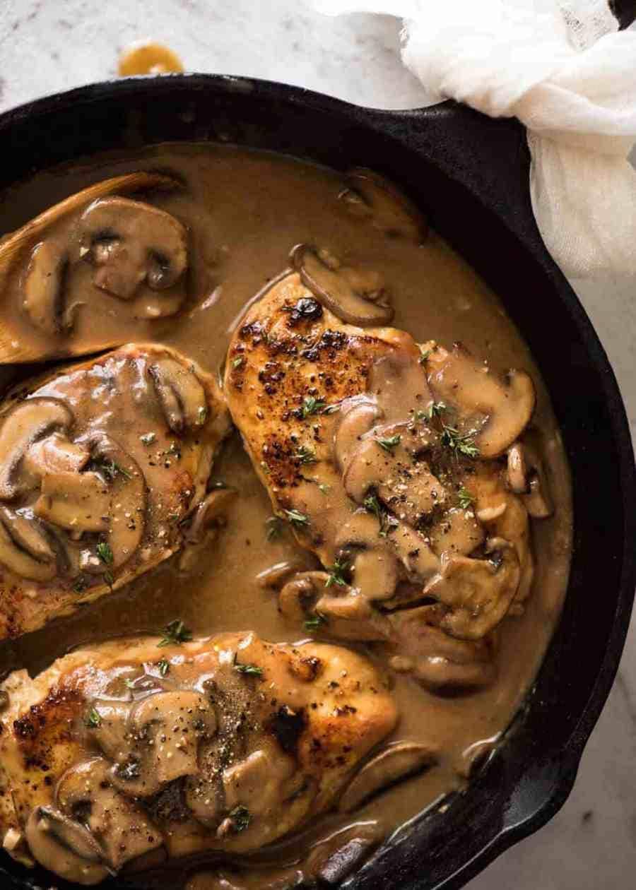 Chicken with Mushroom Gravy on a cast iron garnished with thyme