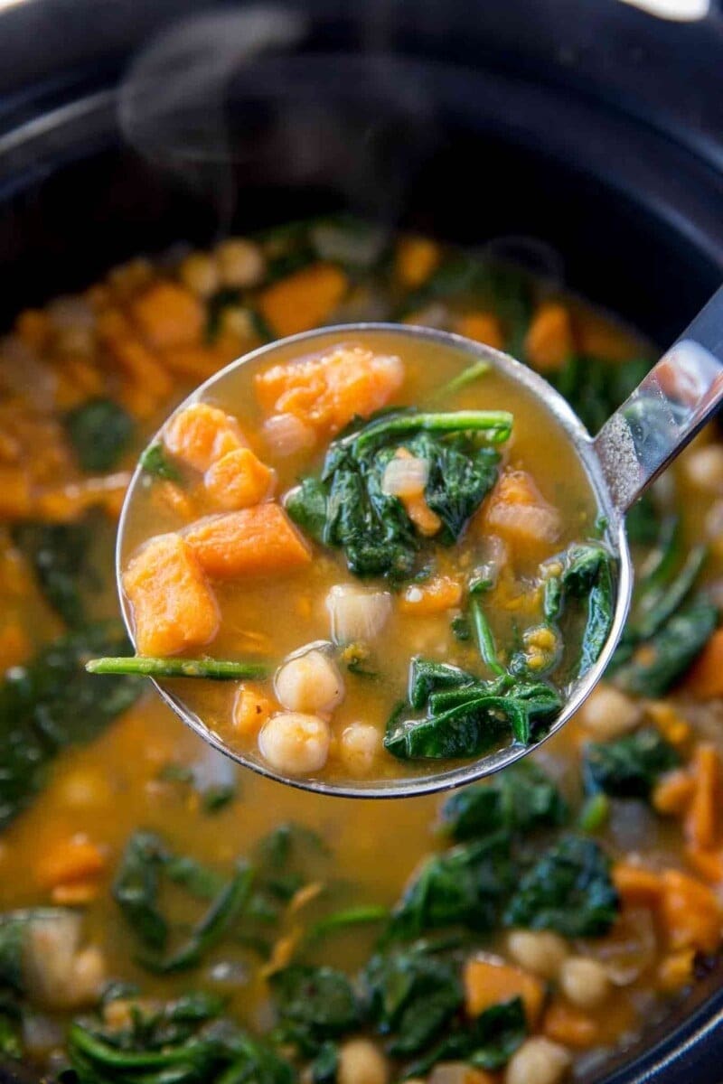 Ladle scooping on a pot of Chickpea Sweet Potato Stew