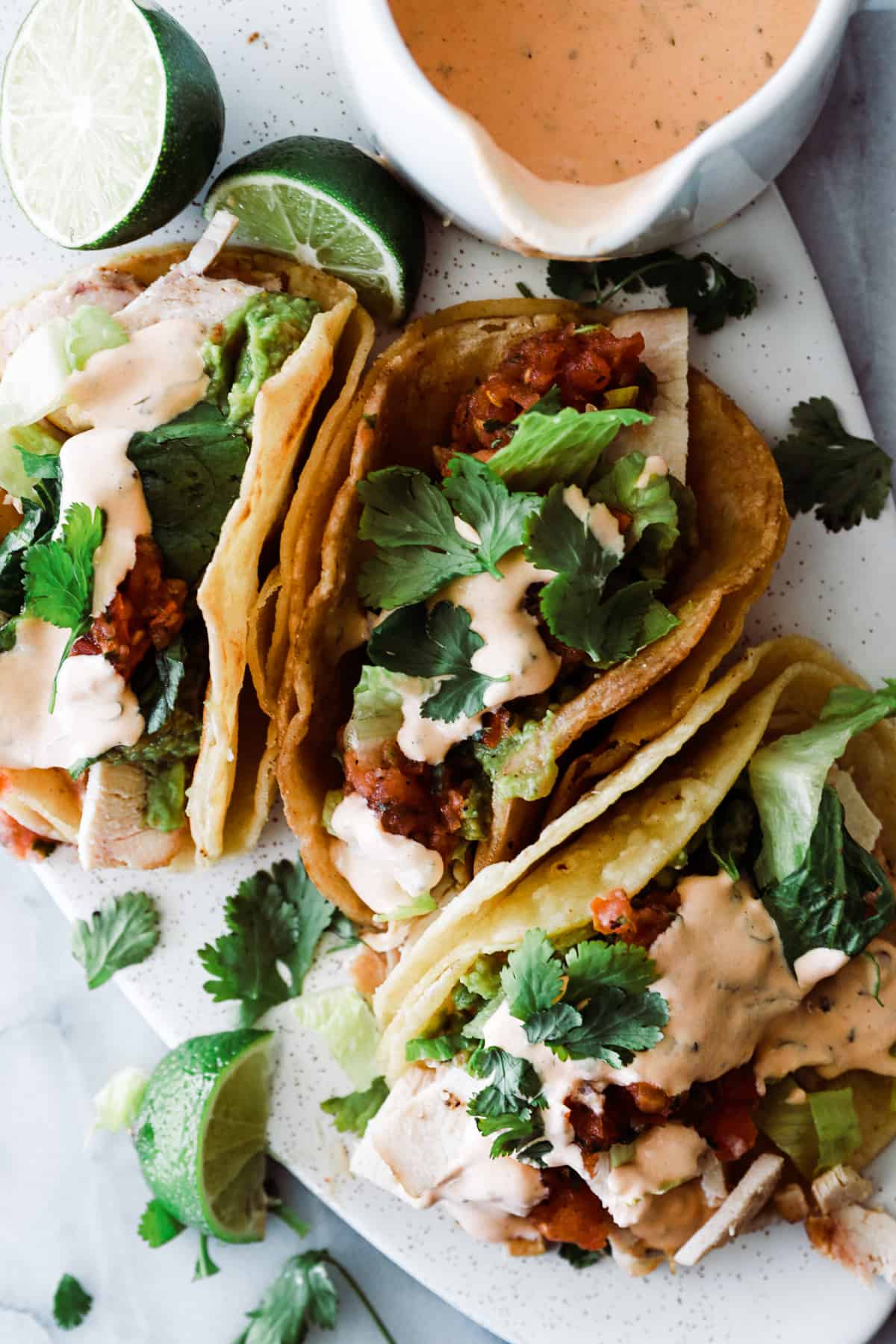 Homemade tacos with chipotle cream sauce, bacon and lime