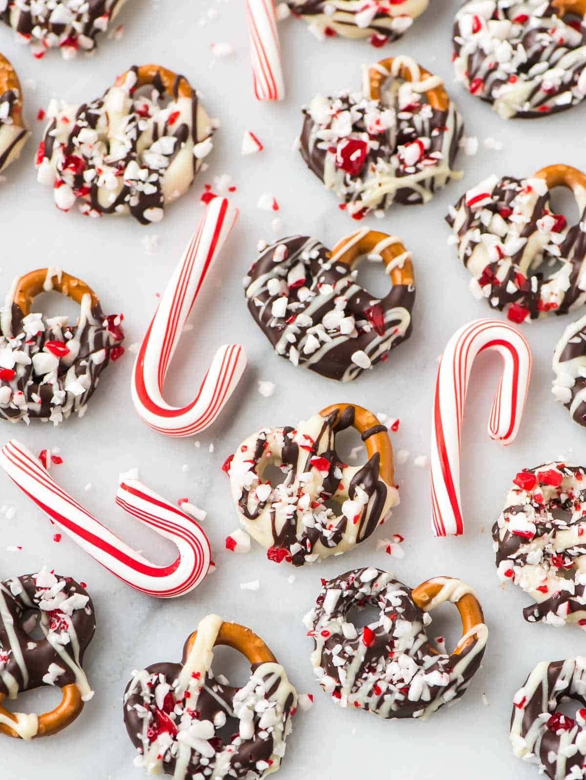 Pretzels covered with white and dark chocolate rolled into crushed peppermint candy cane.