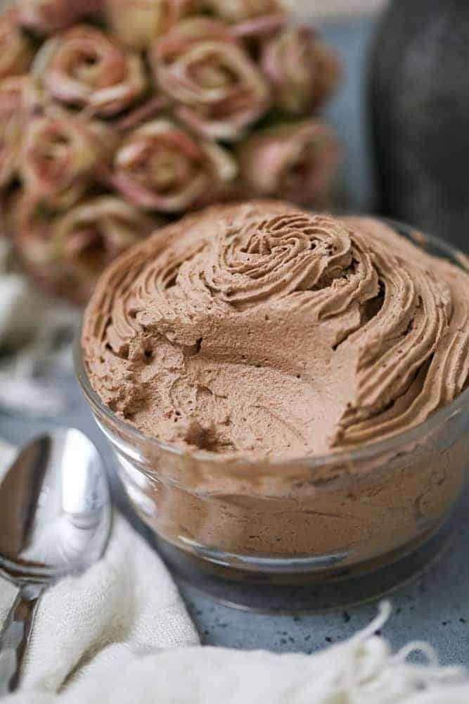 Chocolate mousse in a clear glass jar. 