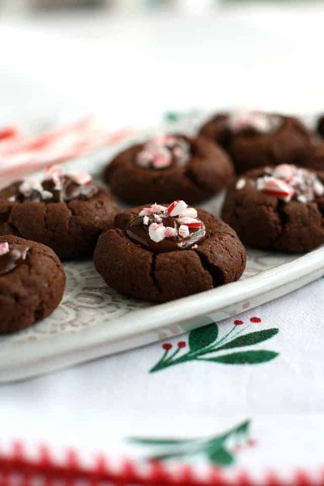Chocolate thumbprint cookies with chocolate filling and crushed candy cane on top. 