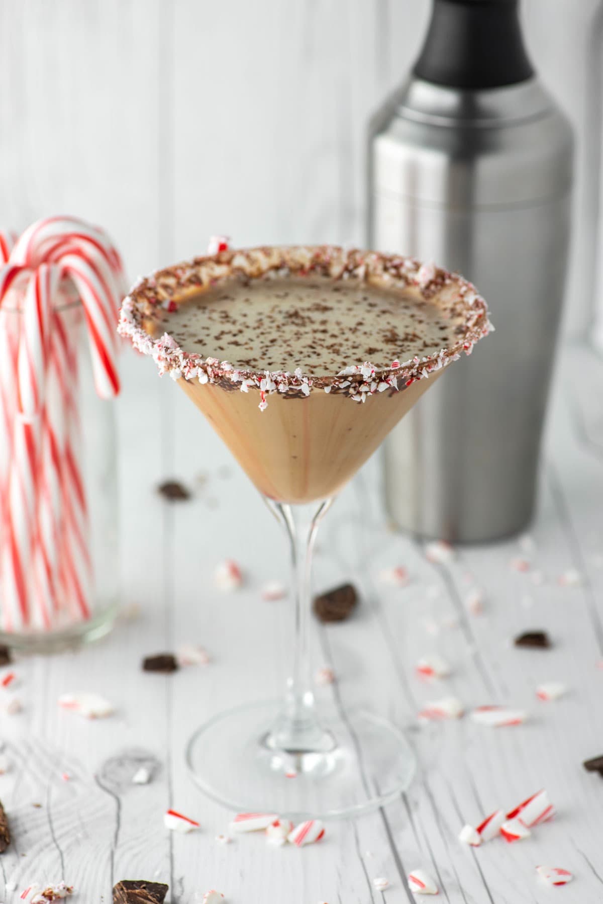 A festive martini with peppermint syrup and candy canes.