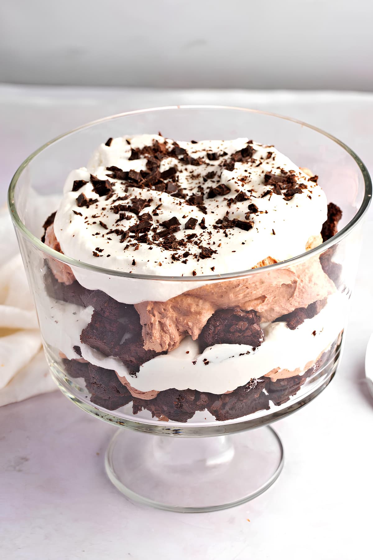 A Glass Bowl of Homemade Chocolate Trifle with Brownies, Whipped Cream and Chocolate Shavings