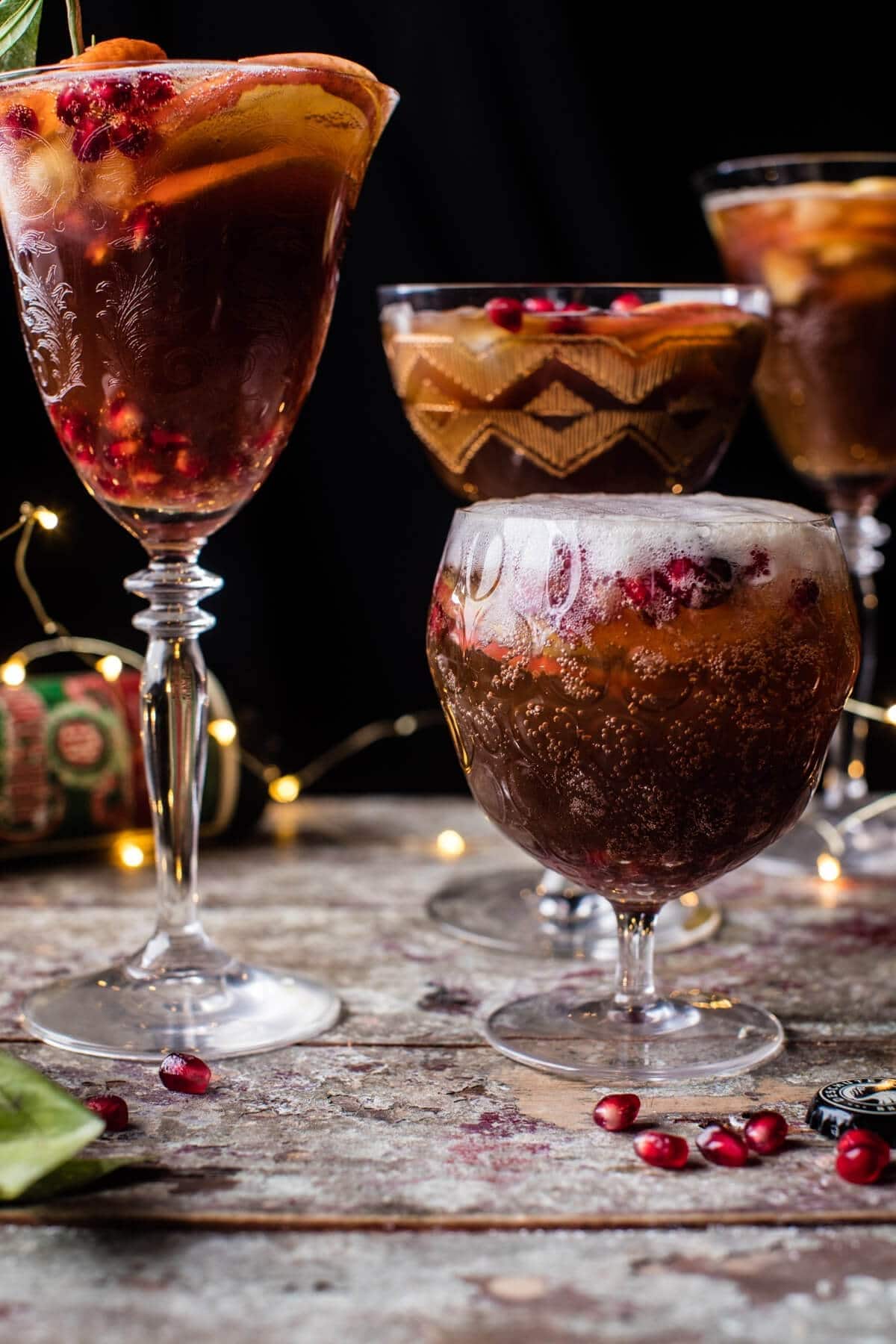 Three glasses of sangria with fruit and spices.