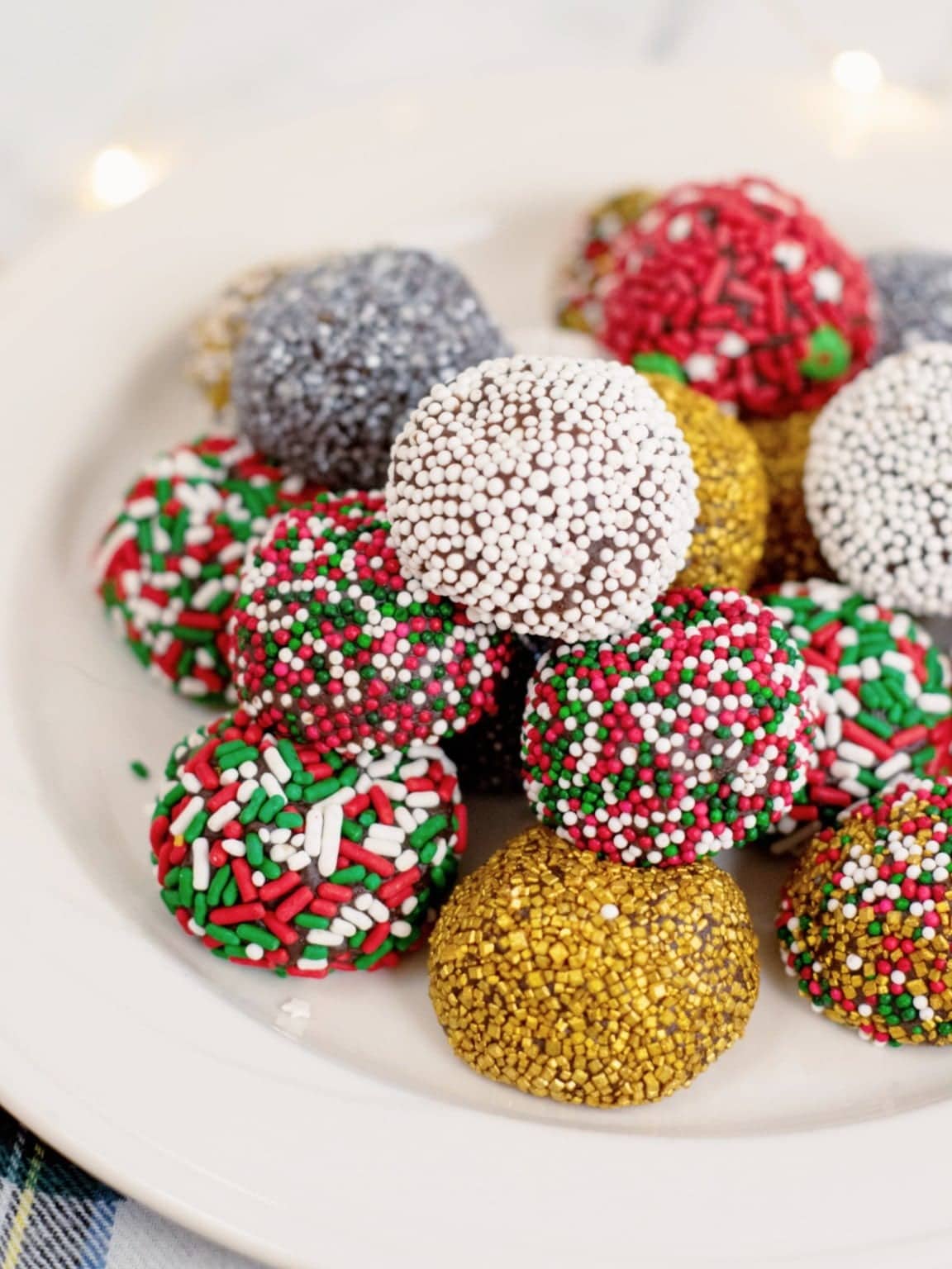 Christmas brownie truffles coated with candies and sprinkles.
