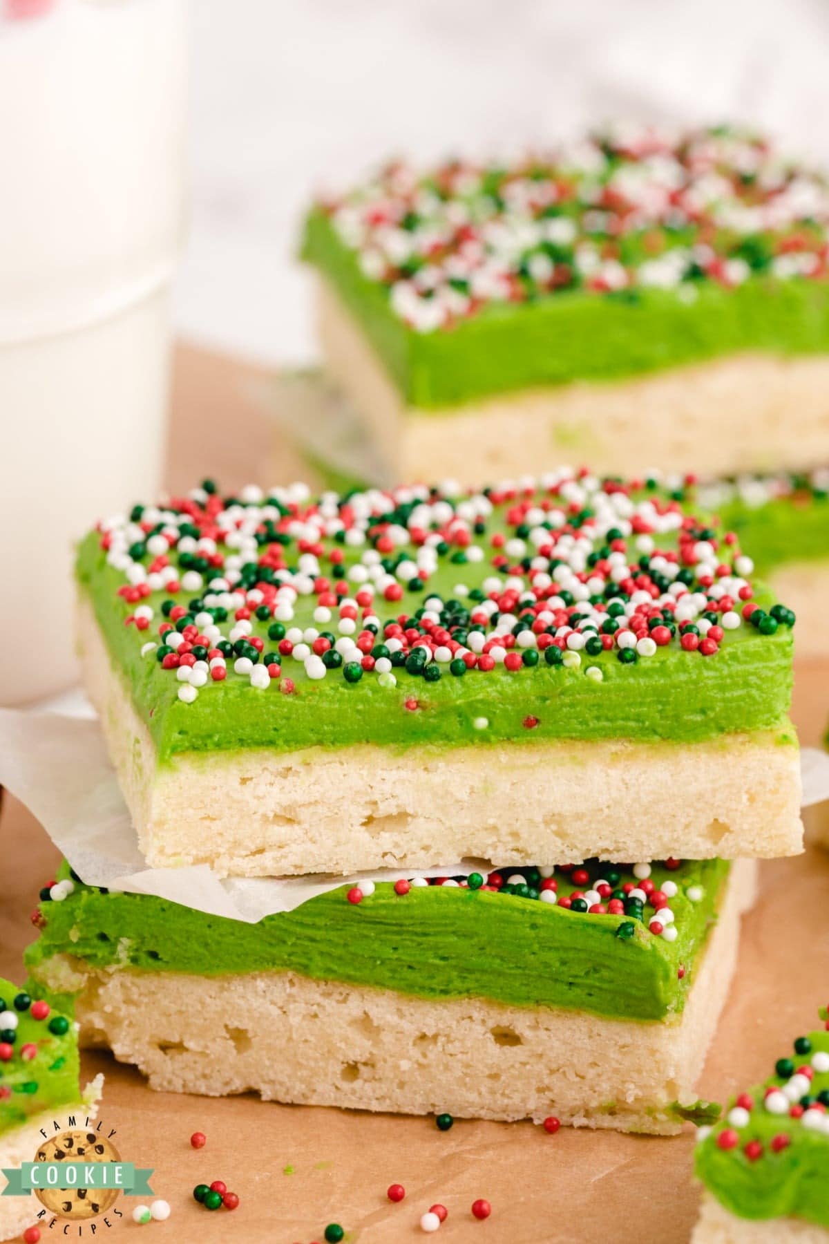 Sugar cookie bars with green frosting and sprinkles.
