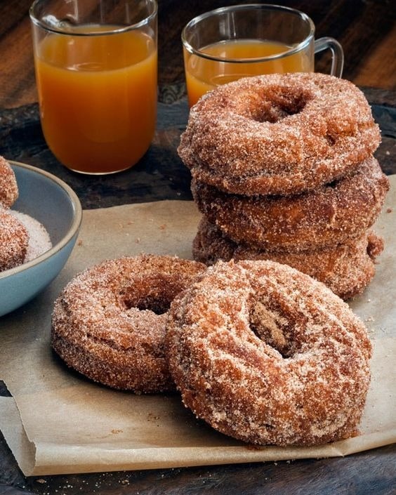 Apple cider doughnuts covered with white sugar. 