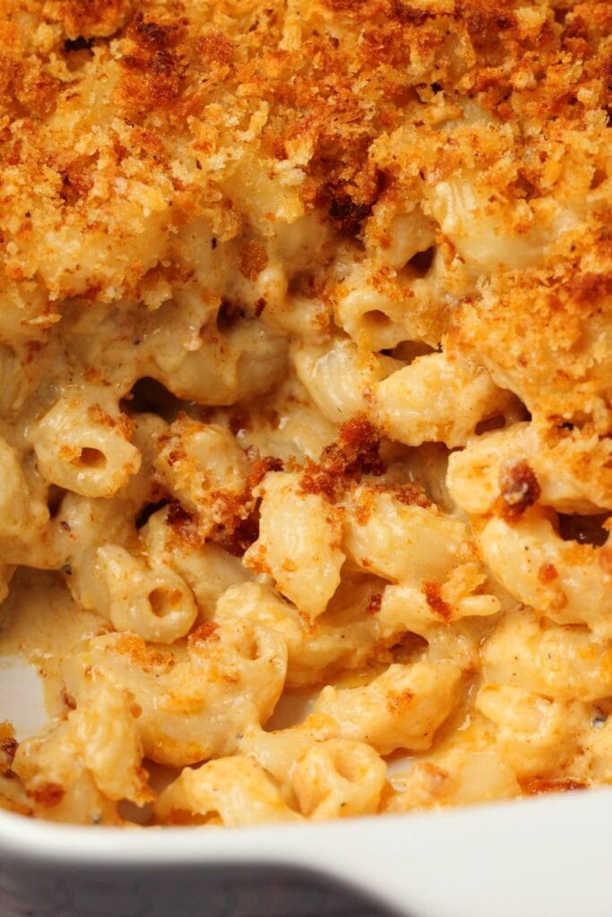 Baked mac and cheese in a white casserole dish. 