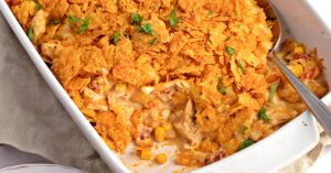 Chicken dorito casserole in a white dish, topped with golden breadcrumbs. A delicious and comforting meal