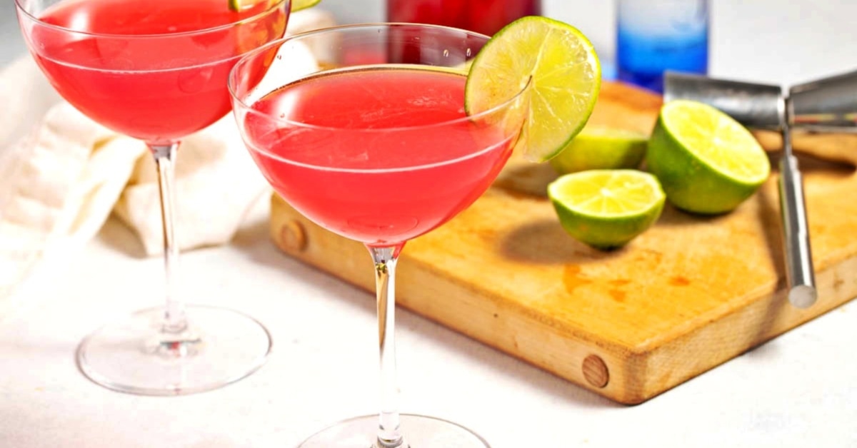 Homemade pink cosmopolitan cocktail garnished with lime