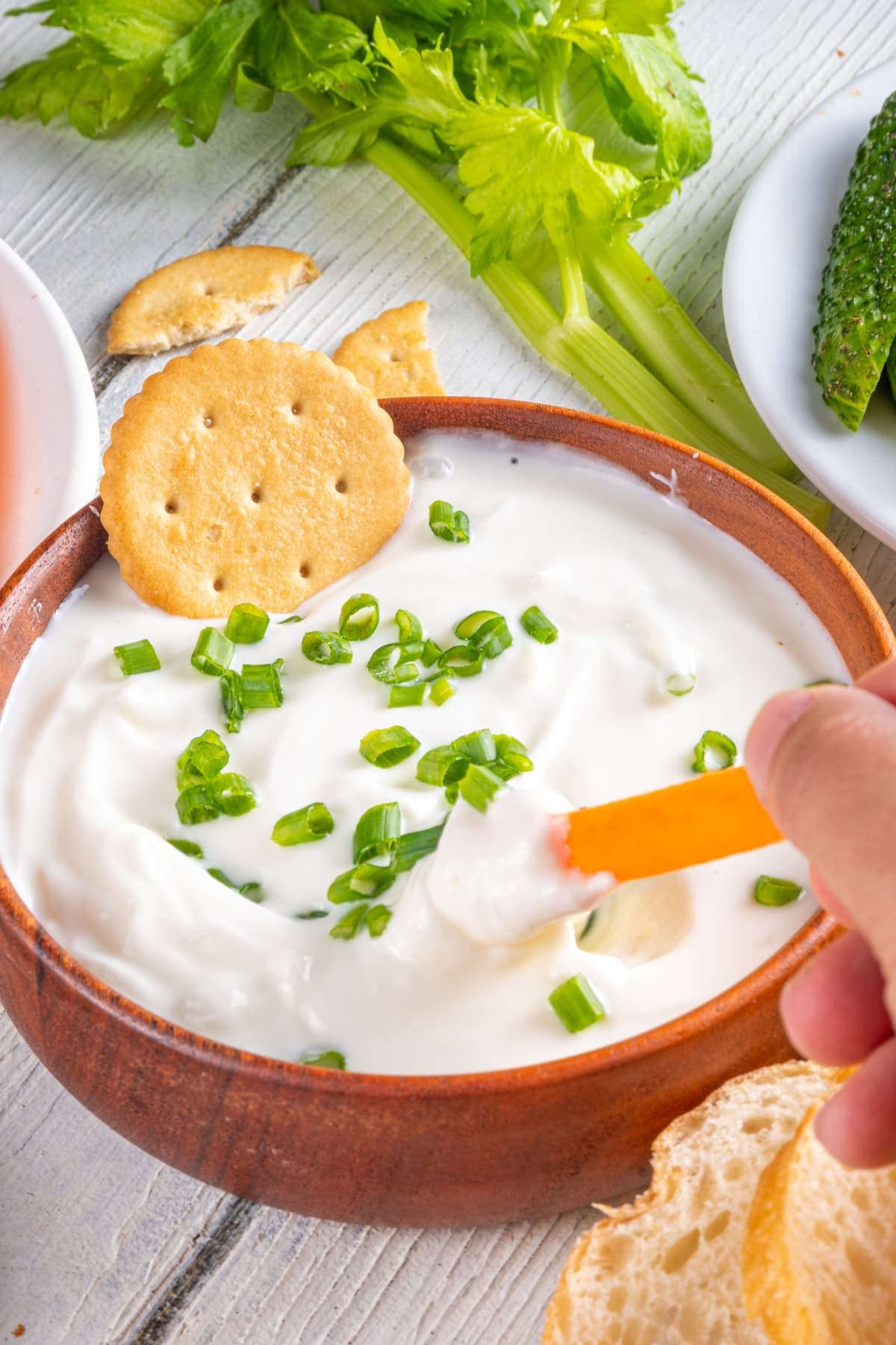 Whipped cottage cheese dip on a wooden bowl.