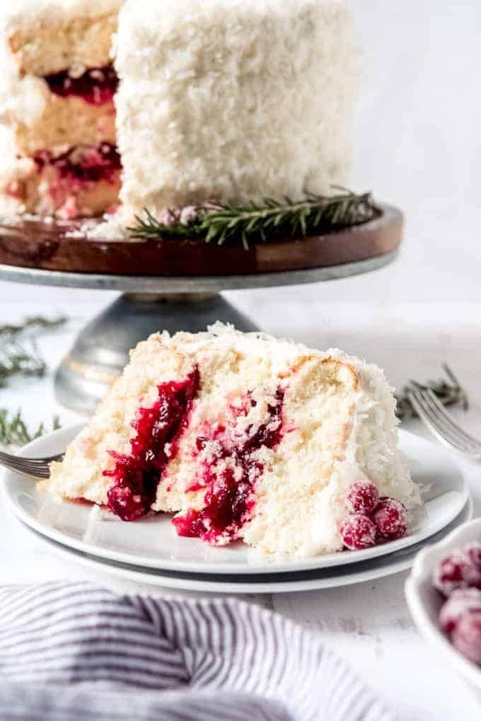 Sliced coconut cake with sugared cranberry filling.
