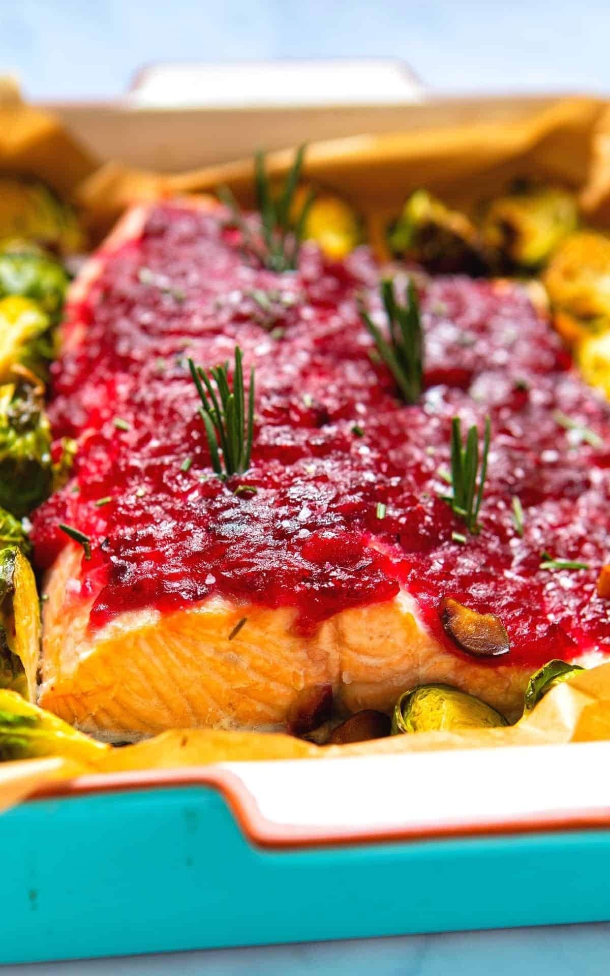 Baked salmon topped with cranberry sauce.