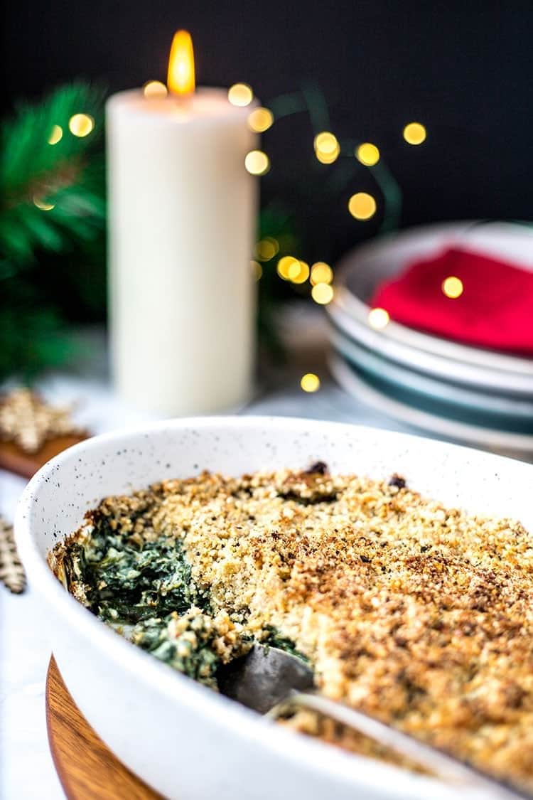 Spinach gratin with crumbly toppings on a casserole dish. 