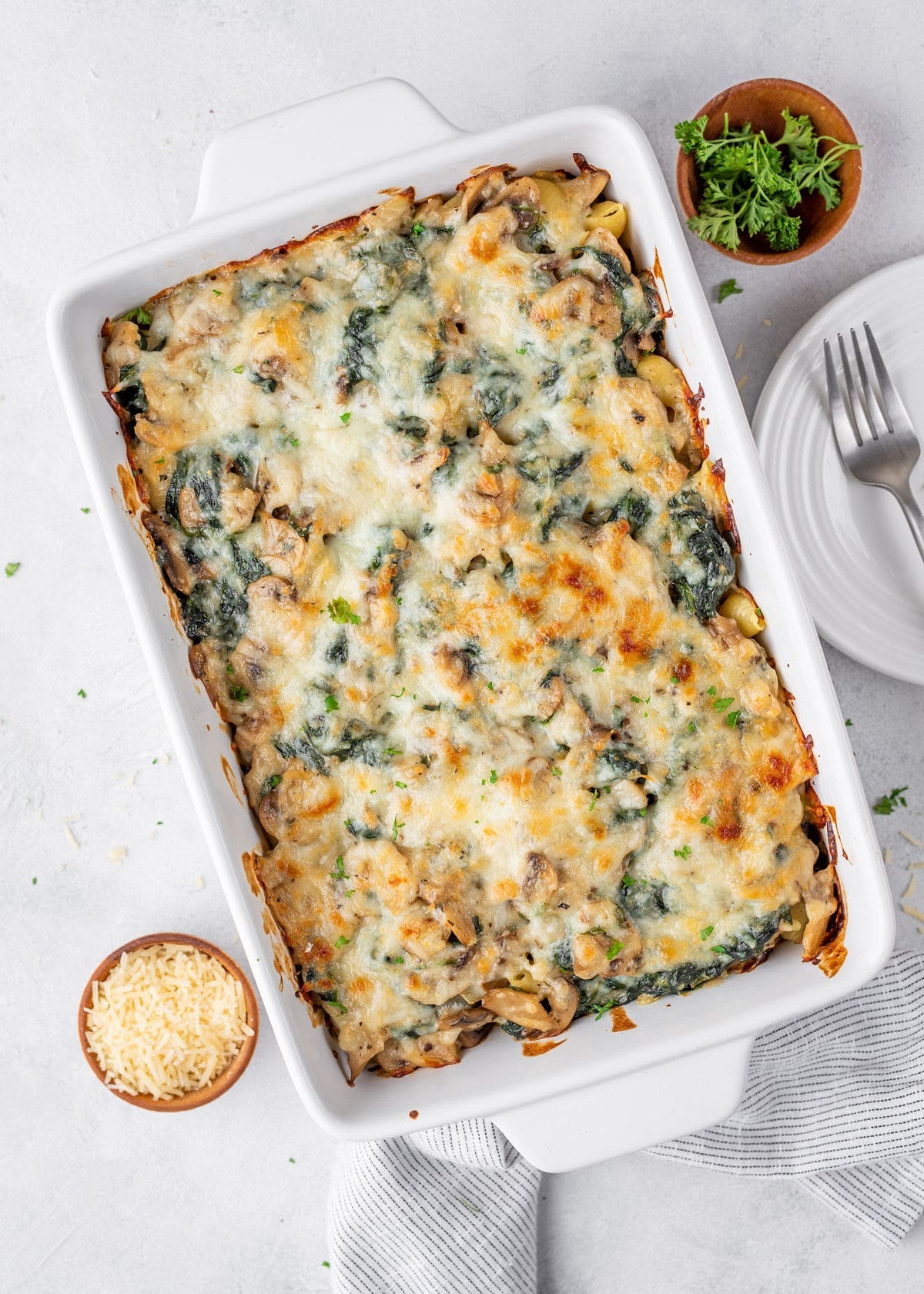 Casserole made with tender pasta, buttered spinach, and mushroom coated in Parmesan cream sauce.