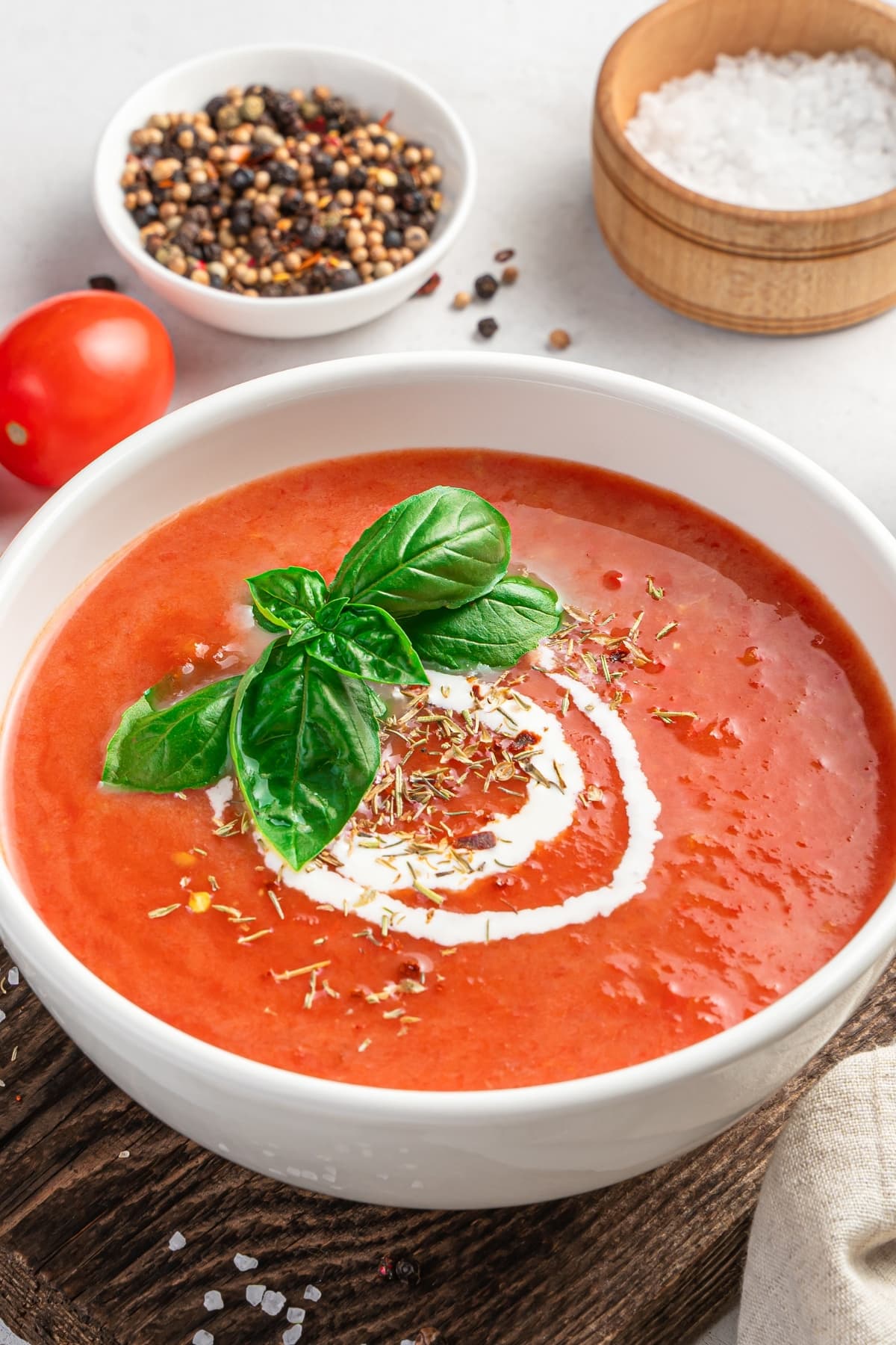 A Bowl of Tomato Soup Topped with Basil and Cream