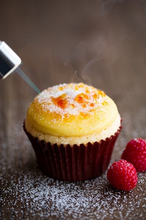 Cupcake topped with vanilla bean pastry cream topping and a caramelized brulee crisp.