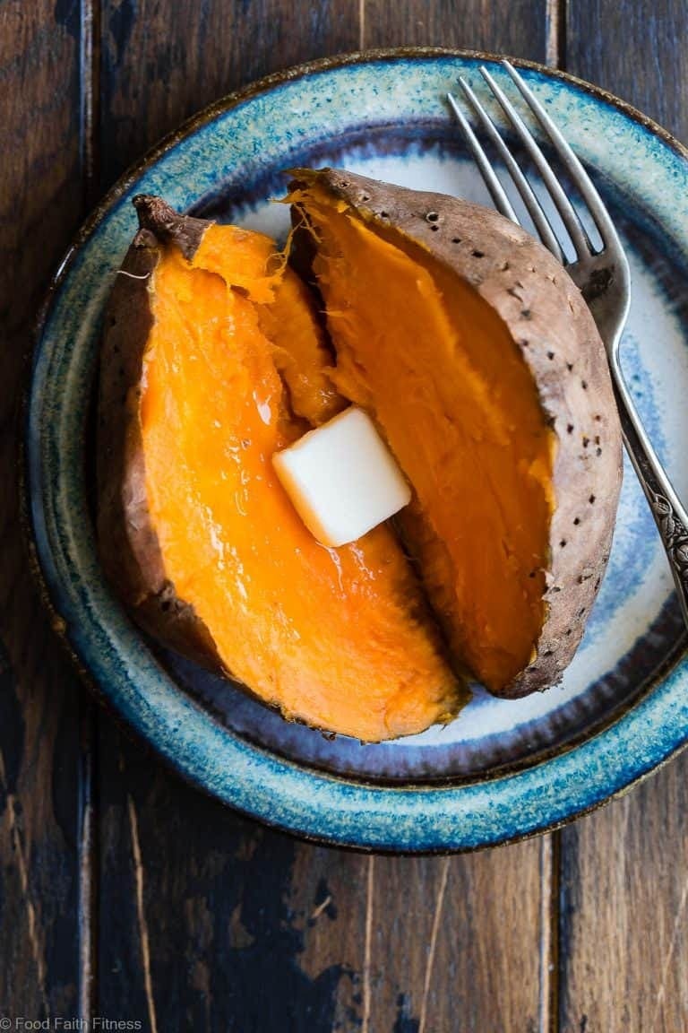 Slice in half baked sweet potato with butter in the middle.