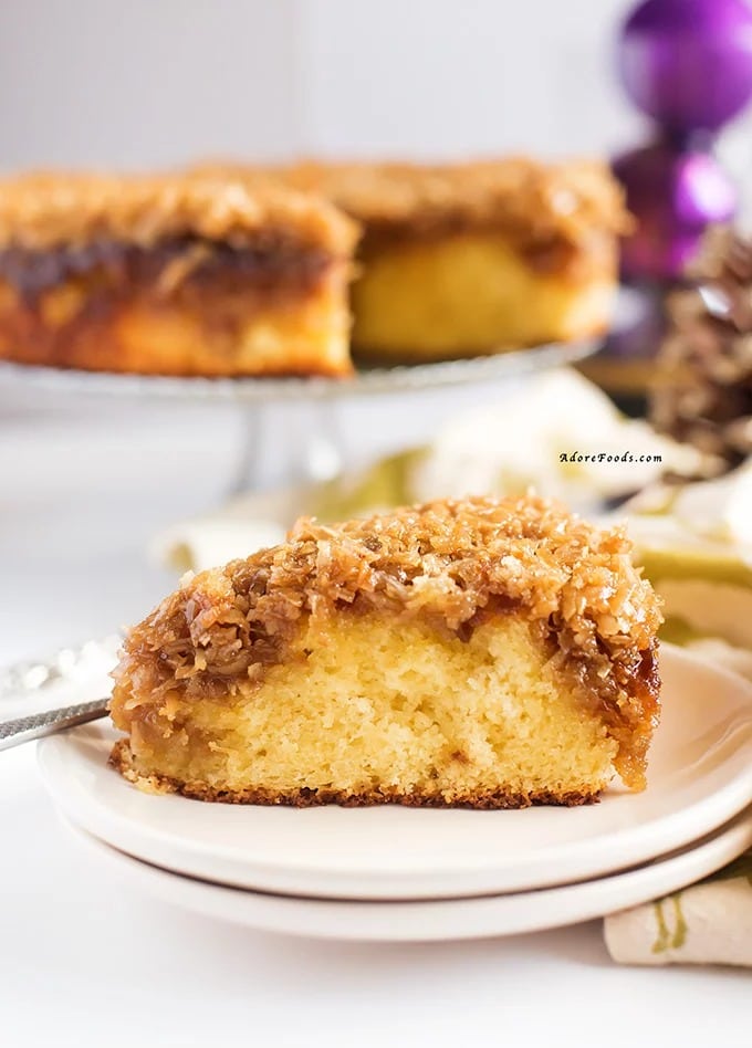 Slice of Danish dream cake with caramelized coconut topping.