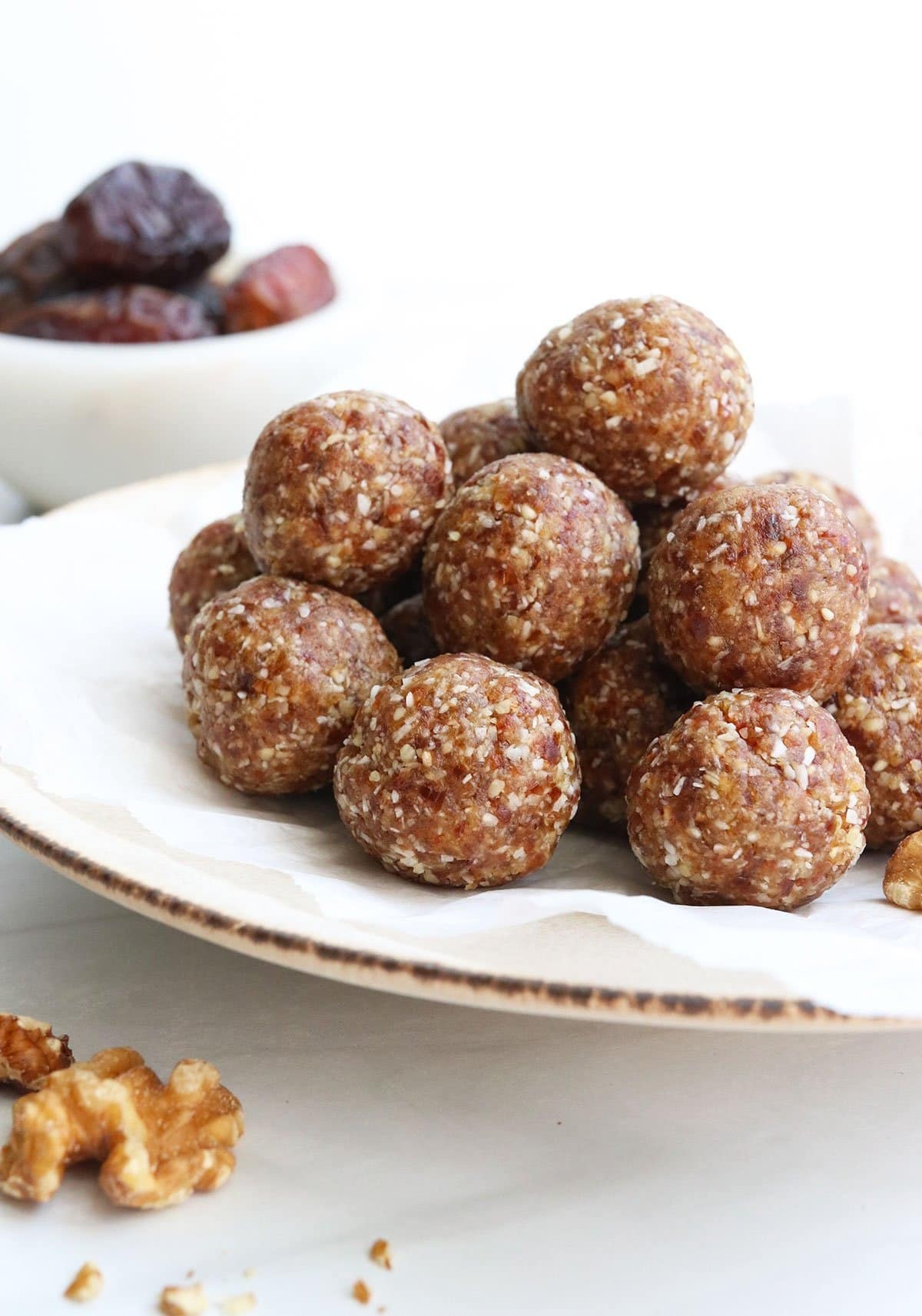 Bunch of date balls in a white plate.