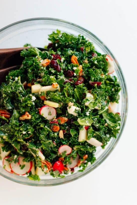 Raw kale salad with chopped Granny Smith apple, cranberries, toasted pecans and goat cheese, tossed in honey mustard dressing