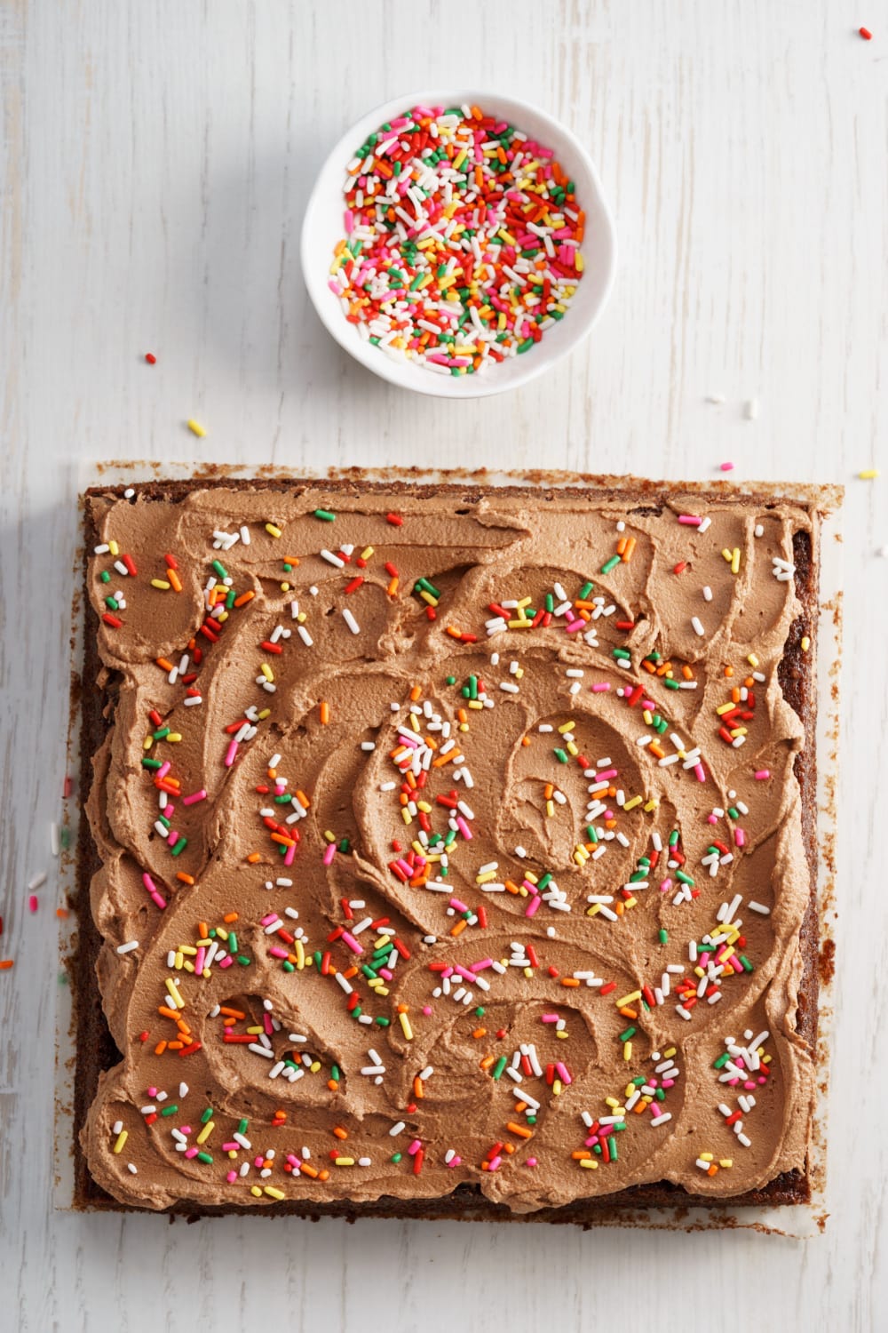Chocolate Depression Cake (Wacky Cake) with spread of buttercream frosting on top and sprinkles. 