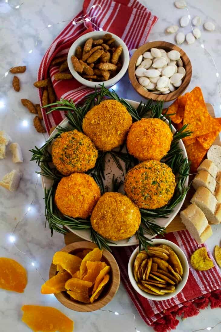Cheeseballs coated with crushed Dorito chips decorated as Christmas wreath on a plate. 