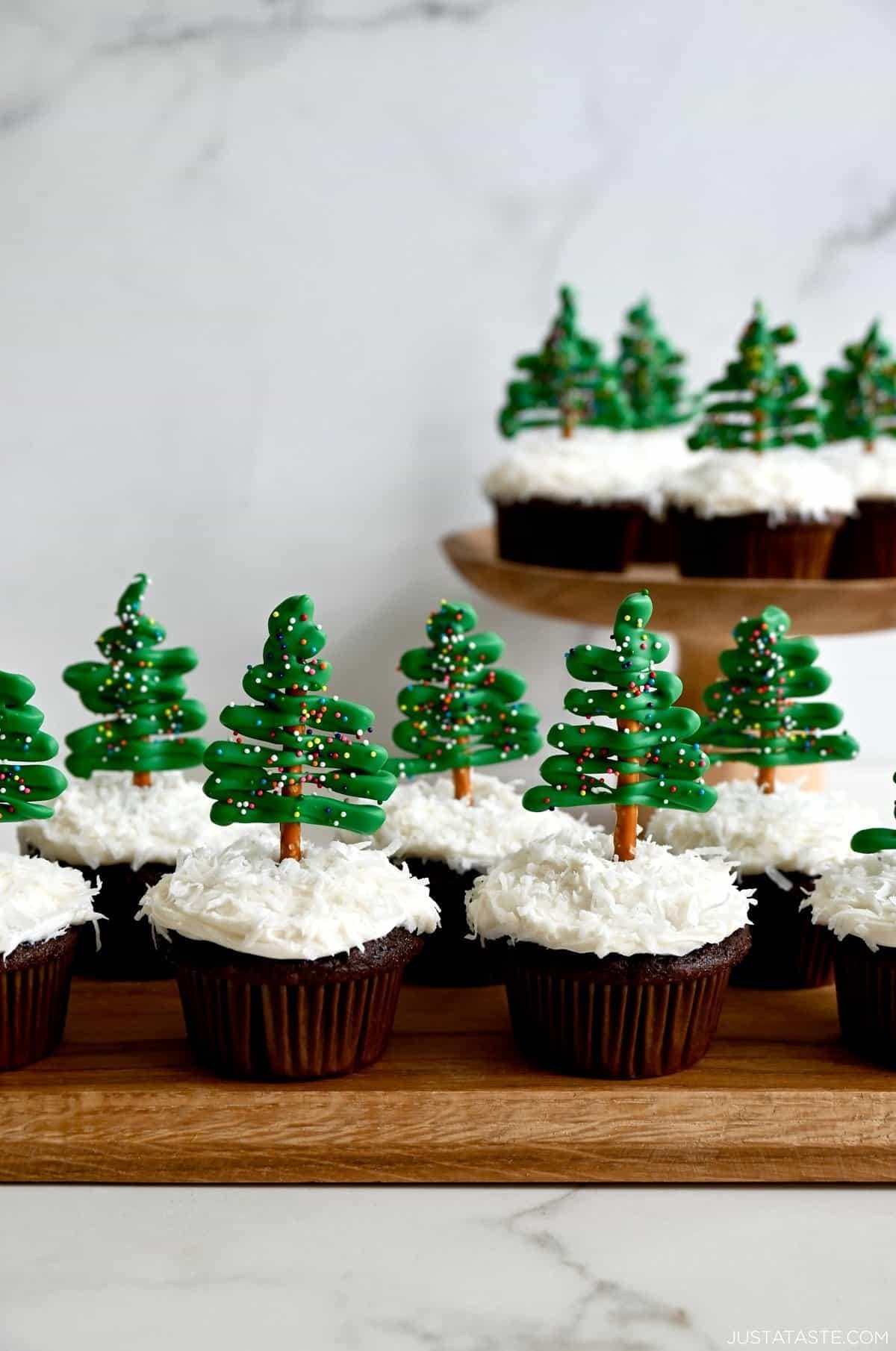 Cupcakes topped with Christmas tree frosting on stick.
