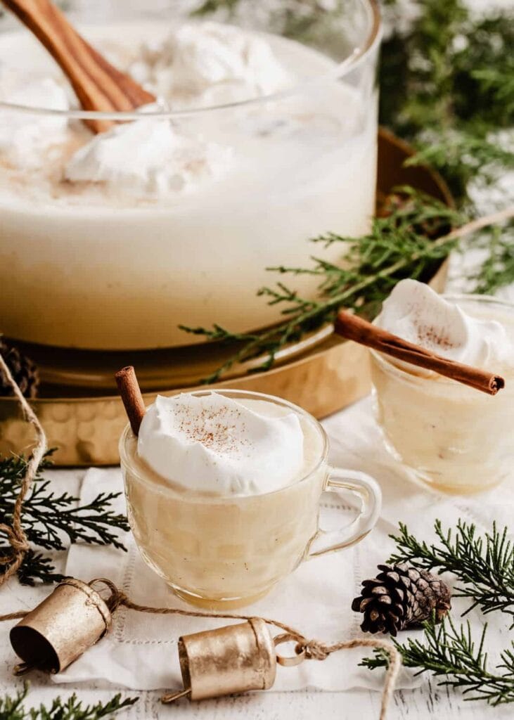 Servings of eggnog punch topped with whipped cream. 