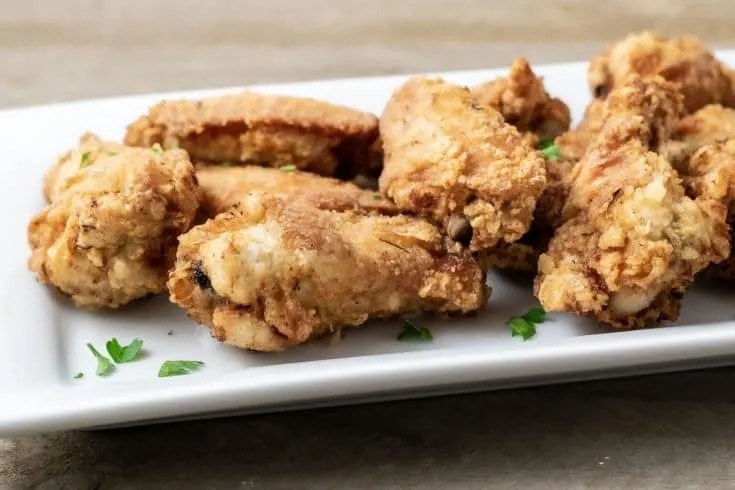 Fried chicken wings in a serving plate. 