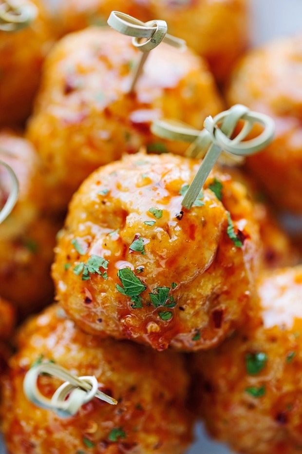 Bunch of chicken meatballs with spicy sauce. 