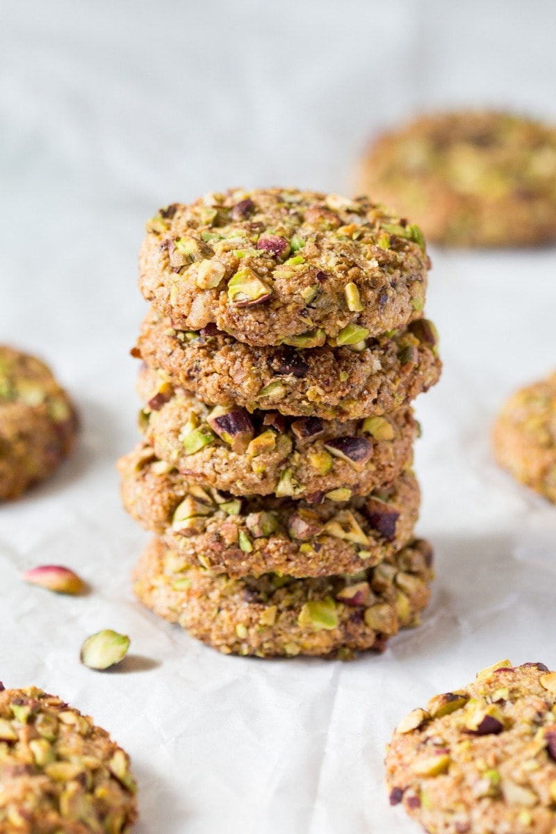 Stack of oatmeal pistachio cookies with ground almonds and berries. 