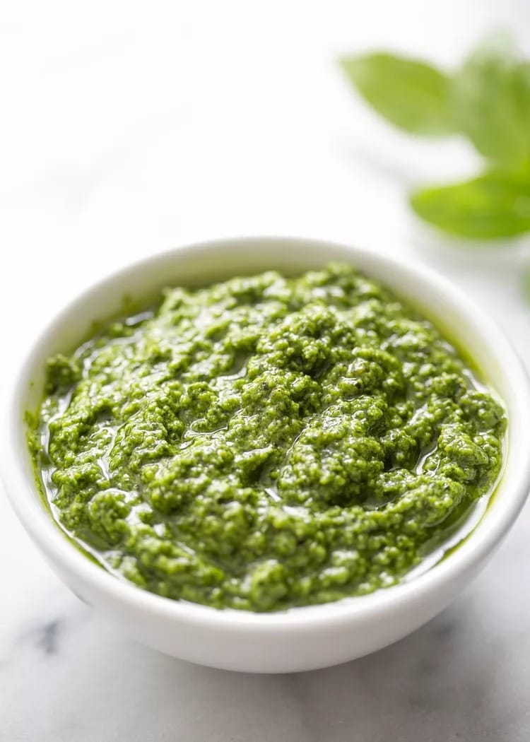fresh basil pesto in a small container