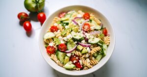 Pasta Salad with tomatoes, cucumber, red onion, feta, and avocado