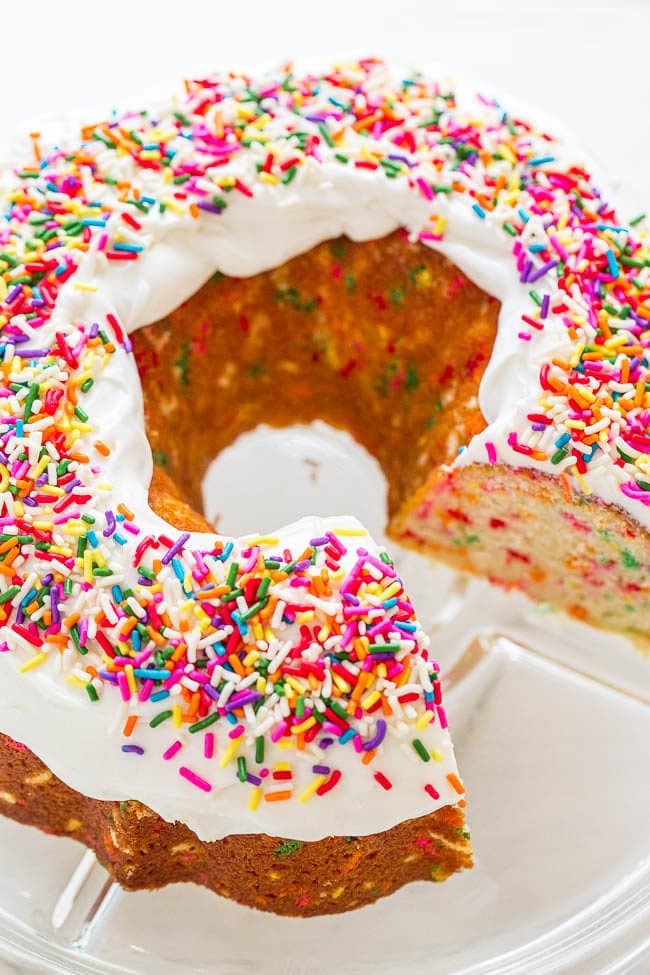 Bundt cake topped with icing and sprinkles. 